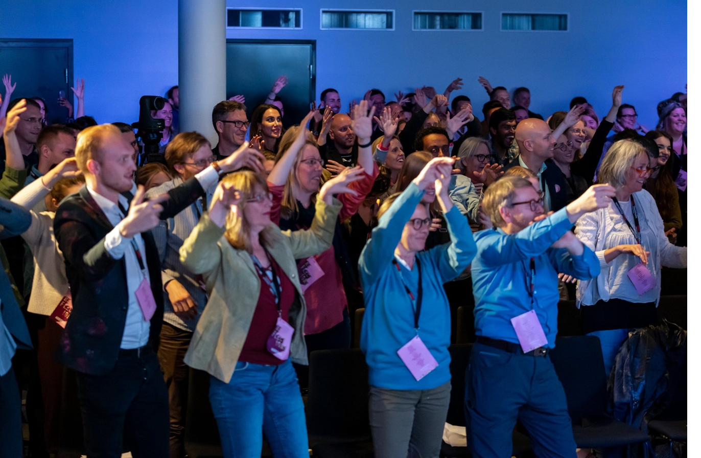 Conference guests dancing and singing along