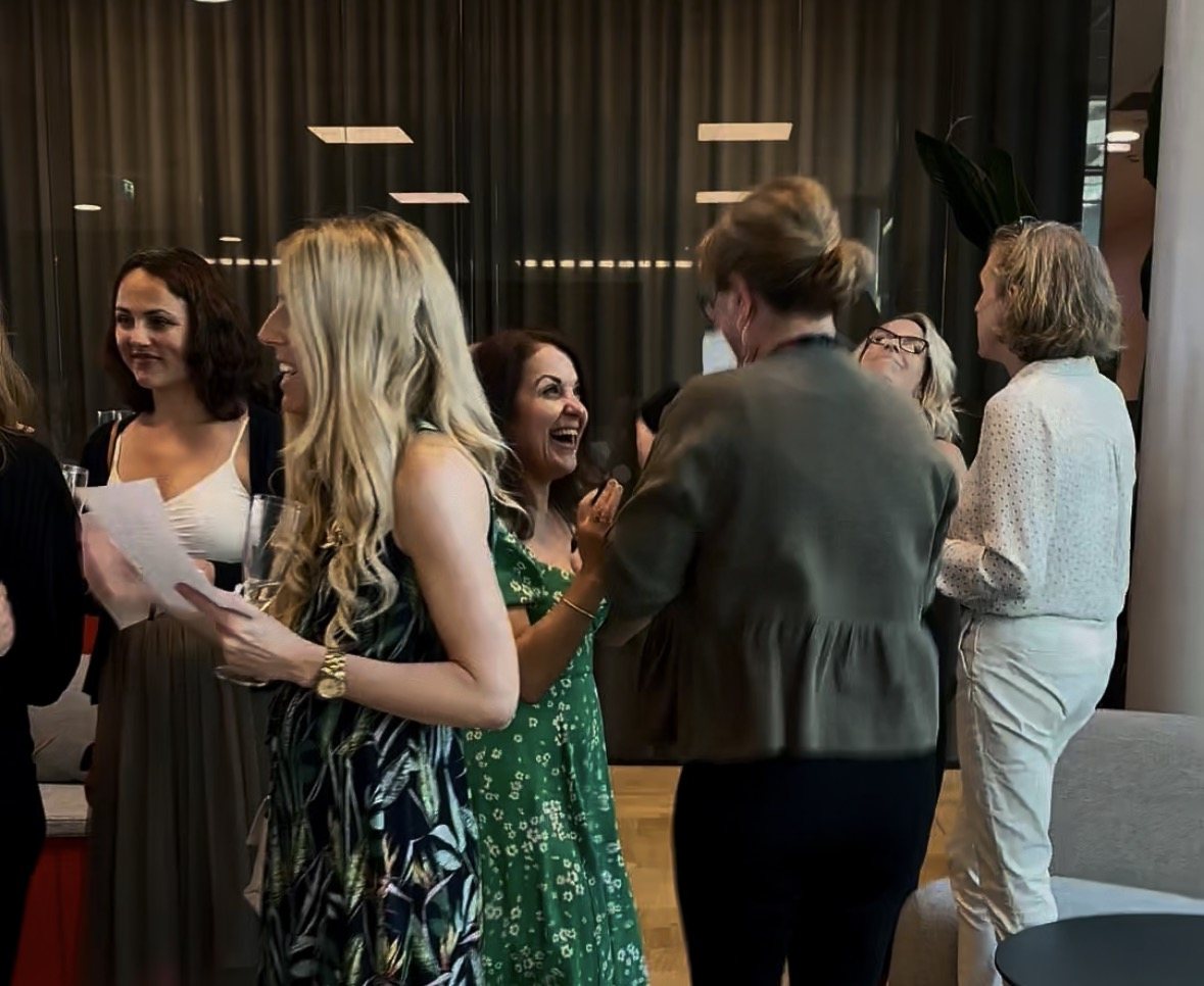 Guests laughing with their bingo cards in hand