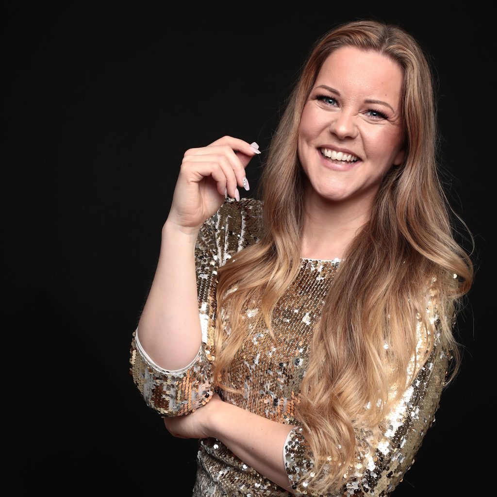 Portrait, gold dress, black background